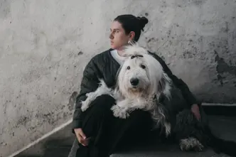 Woman sitting cross-legged on the floor with a bobtail on her lap