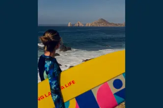 Woman with a surfboard under her arm