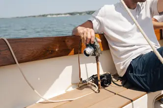 Riley on a boat with his Leica in his hand