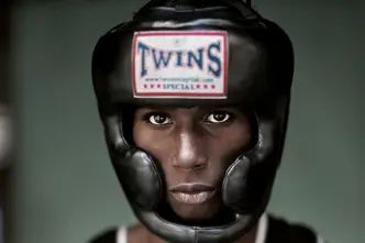 Portrait of a black boxer wearing a boxing helmet