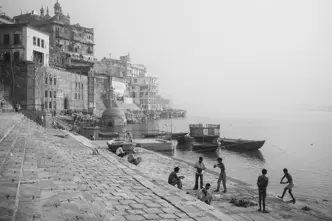 Black-and-white photo of people at a harbour in India
