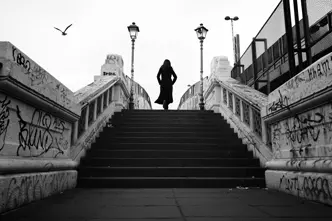 black-and-white photograph, woman running up a flight of stairs