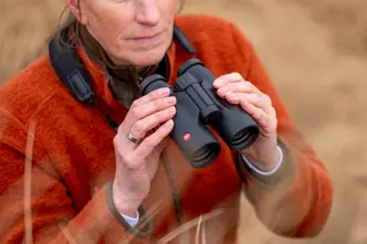 Woman is holding her Leica Trinovid