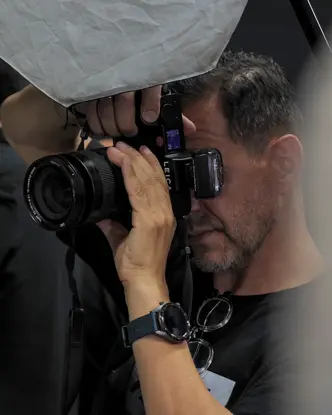 Close-up of a man taking a picture in a studio.