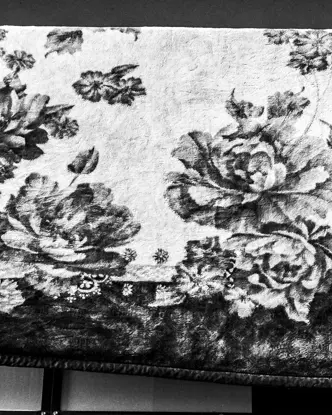 A patterned ceiling hangs over a railing