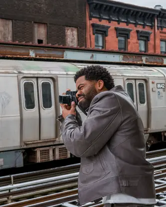 Man photographs a train with a Leica M11