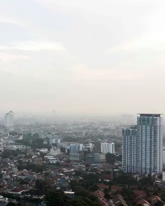 View of a foggy city with tower blocks.
