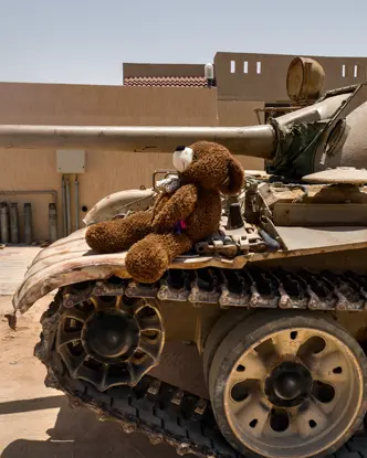 Teddy bear sitting on a tank