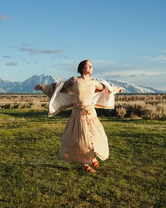 Happy woman with white dress on a meadow
