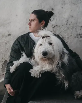 Woman sitting cross-legged on the floor with a bobtail on her lap