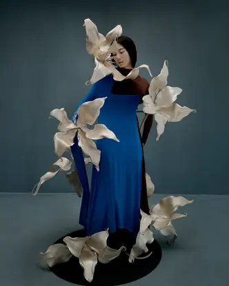 Woman in a blue dress with big flowers