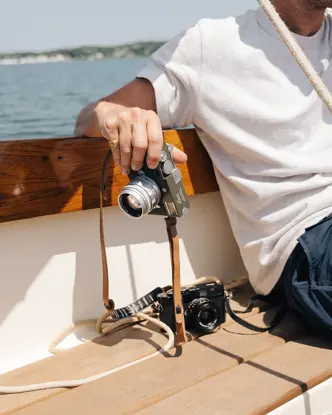 Riley on a boat with his Leica in his hand