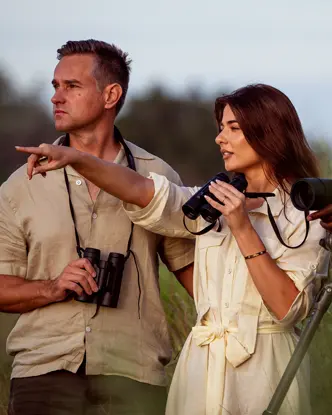 Three people are watching the wildlife