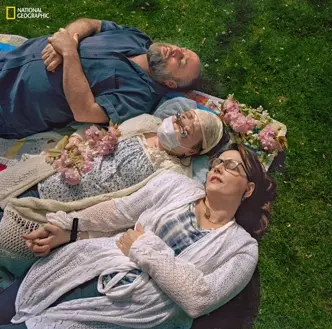 Katie with her family laying in grass