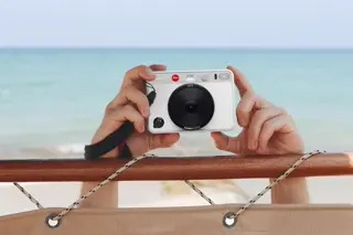 White Leica sofort Camera at the beach