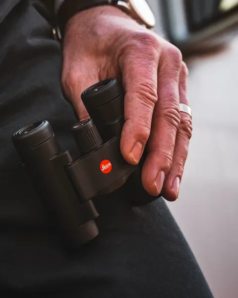 Leica-compact-binoculars-held-by-a-man