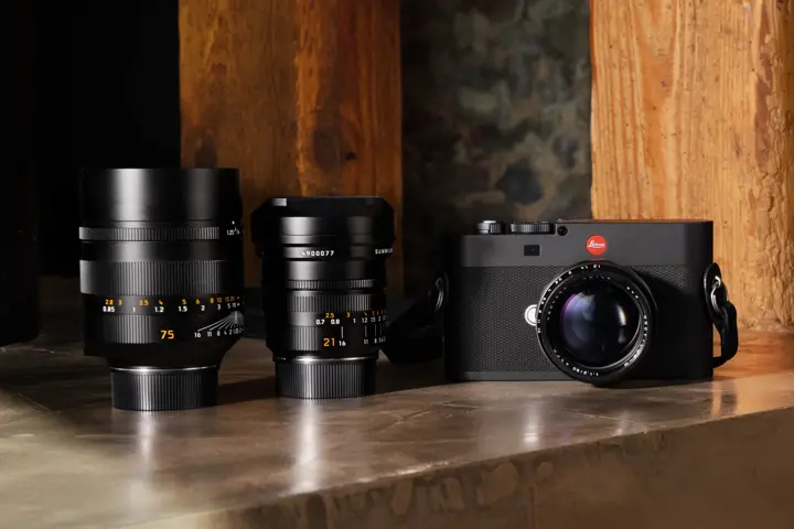 Leica M EV1 with three lenses on a desk