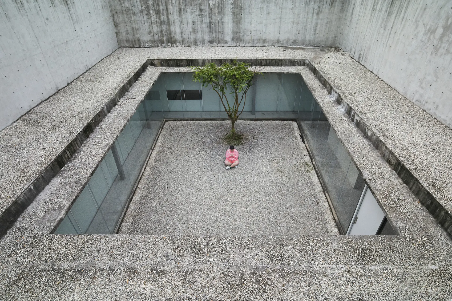 Man praying near a tree